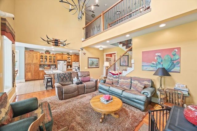 292 Mclerran Cemetery Rd, Moss, TN 38575 - living room featuring light wood-style flooring, a chandelier, stairs, a towering ceiling, and recessed lighting