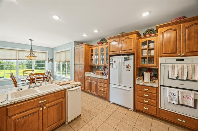 292 Mclerran Cemetery Rd, Moss, TN 38575 - kitchen with white appliances, brown cabinets, decorative light fixtures, glass insert cabinets, and recessed lighting