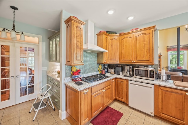 292 Mclerran Cemetery Rd, Moss, TN 38575 - kitchen with appliances with stainless steel finishes, wall chimney exhaust hood, decorative backsplash, light tile patterned floors, and light stone counters