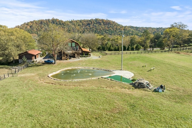 surrounding community with a rural view and a yard