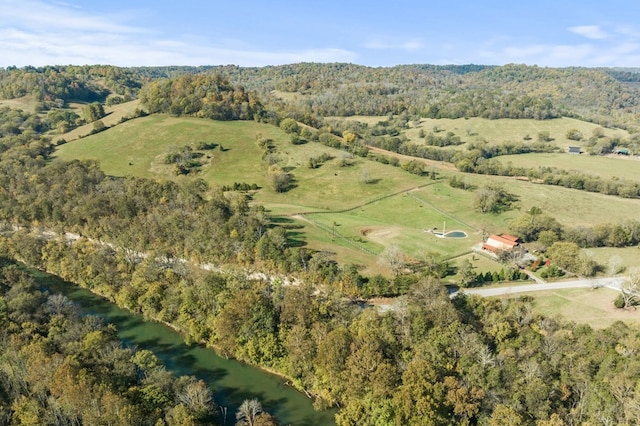 drone / aerial view featuring a water view and a view of trees