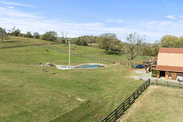 view of yard featuring a rural view and fence