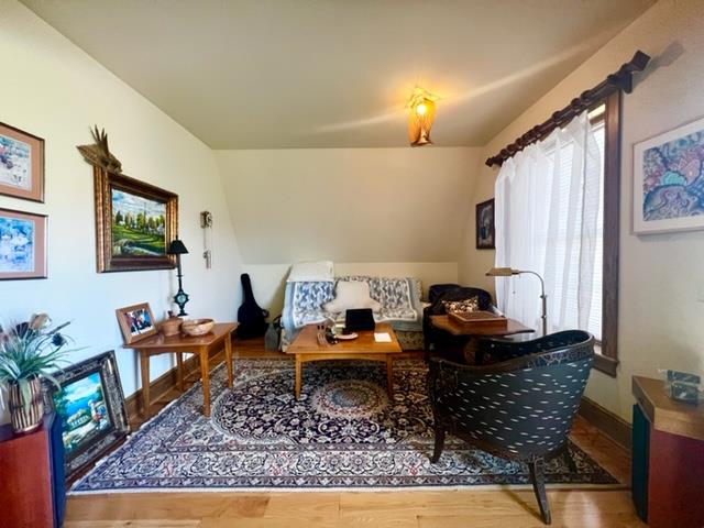 living area featuring wood finished floors and baseboards