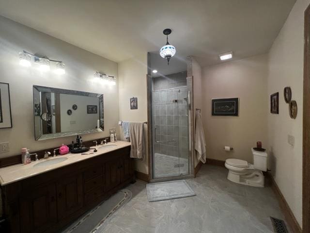 bathroom featuring double vanity, visible vents, toilet, a shower stall, and baseboards