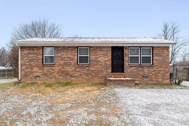 view of front facade with crawl space and brick siding