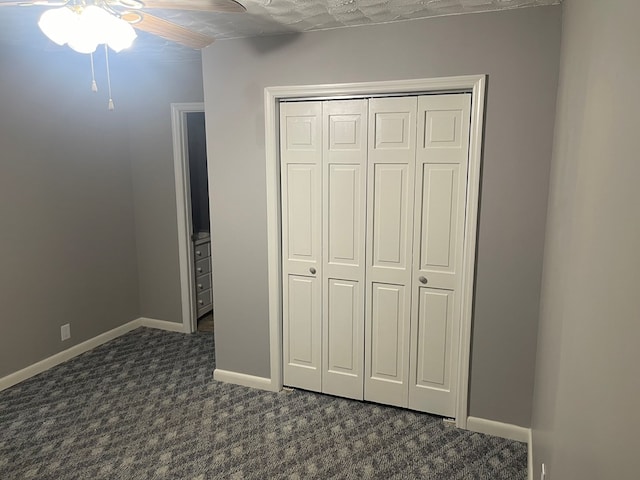 239 Doc Huling Rd, Robbins, TN 37852 - unfurnished bedroom with dark colored carpet, a closet, and a ceiling fan