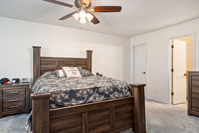 bedroom with ceiling fan, baseboards, and light colored carpet