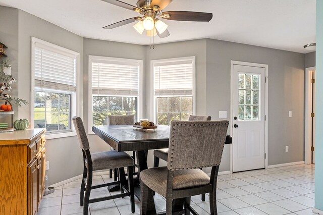 dining room featuring ceiling fan, baseboards, and light tile patterned flooring