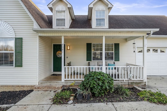 doorway to property with covered porch, roof with shingles, and an attached garage