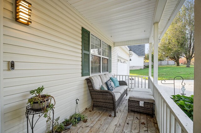 deck with covered porch and a yard