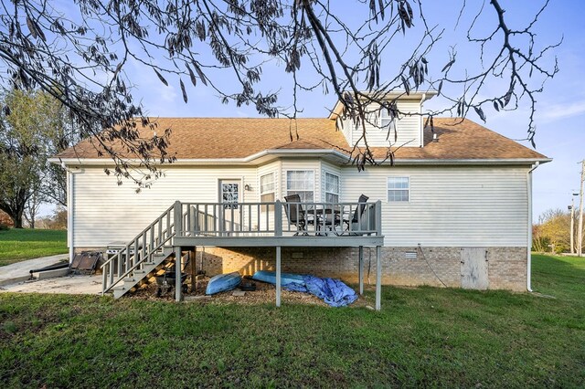 rear view of property featuring a lawn, a deck, and stairs