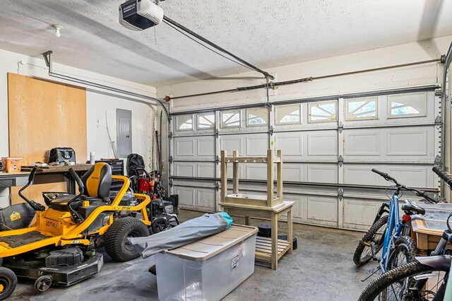 garage with a garage door opener and electric panel