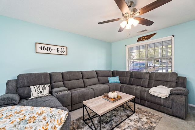 carpeted living area featuring visible vents and ceiling fan