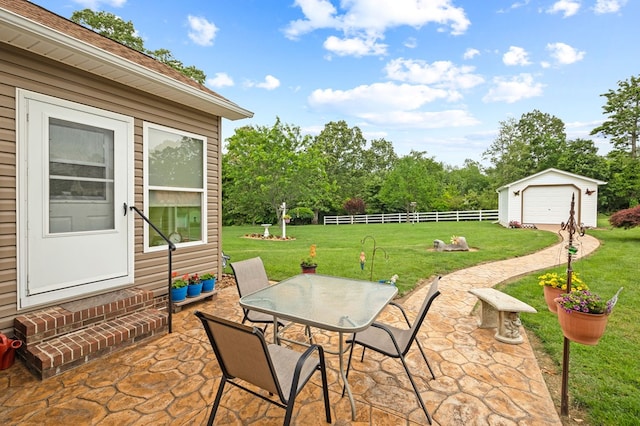 169 Prosperity Dr, Baxter, TN 38544 - view of patio with outdoor dining space, a detached garage, and an outbuilding