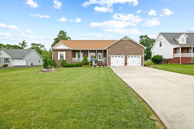 169 Prosperity Dr, Baxter, TN 38544 - view of front of house featuring brick siding, a garage, concrete driveway, and a front yard