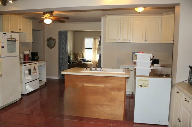 kitchen with light countertops, white appliances, a sink, and a ceiling fan