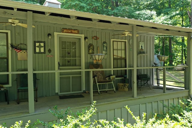 190 Roughshod Ln, Hilham, TN 38568 - view of exterior entry featuring a ceiling fan, board and batten siding, and a chimney
