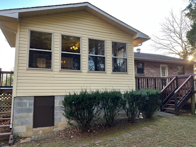 view of side of home featuring a deck and stairway