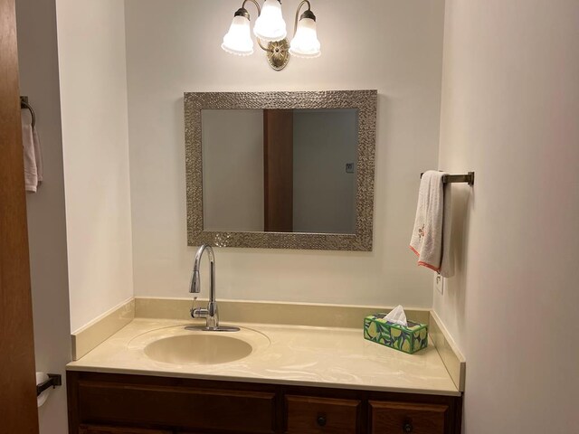 bathroom with a chandelier and vanity