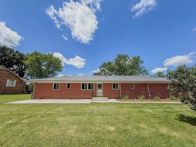540 4th Ave, Baxter, TN 38544 - view of front of property with brick siding, a front lawn, a patio area, a metal roof, and entry steps