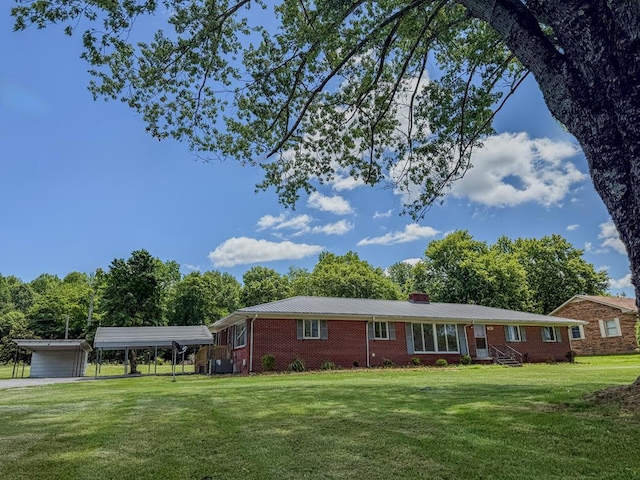 540 4th Ave, Baxter, TN 38544 - ranch-style house featuring a detached carport, brick siding, a front yard, a chimney, and entry steps