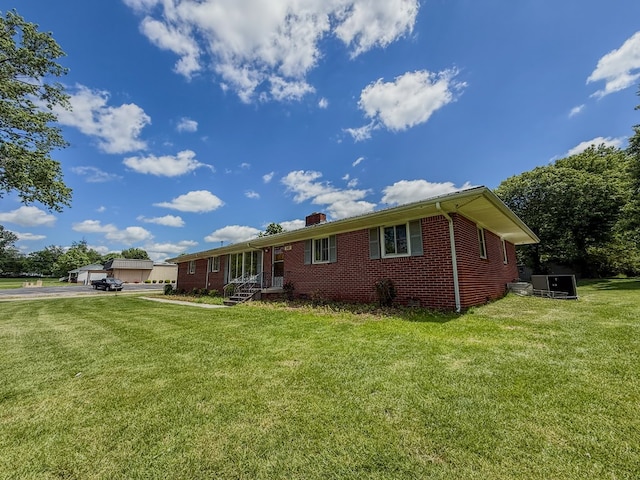 540 4th Ave, Baxter, TN 38544 - view of front of property with brick siding, a chimney, a front lawn, and a garage