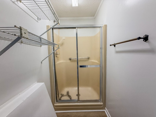 540 4th Ave, Baxter, TN 38544 - full bathroom featuring a stall shower, a textured ceiling, and crown molding