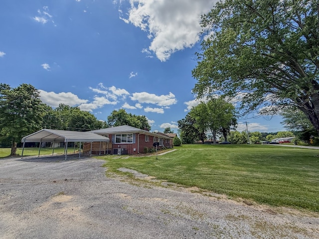 540 4th Ave, Baxter, TN 38544 - view of front facade featuring a carport, gravel driveway, a front yard, and brick siding
