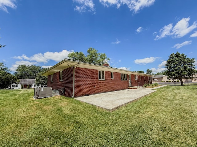 540 4th Ave, Baxter, TN 38544 - back of house with brick siding, a patio area, and a lawn