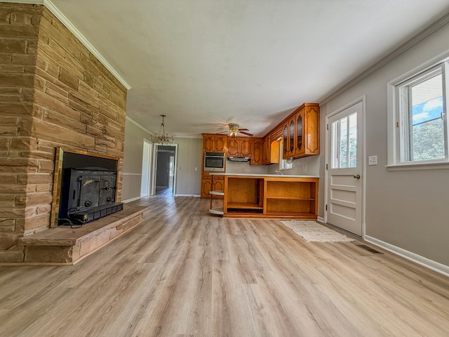 540 4th Ave, Baxter, TN 38544 - kitchen featuring brown cabinetry, ornamental molding, stainless steel oven, light wood finished floors, and light countertops