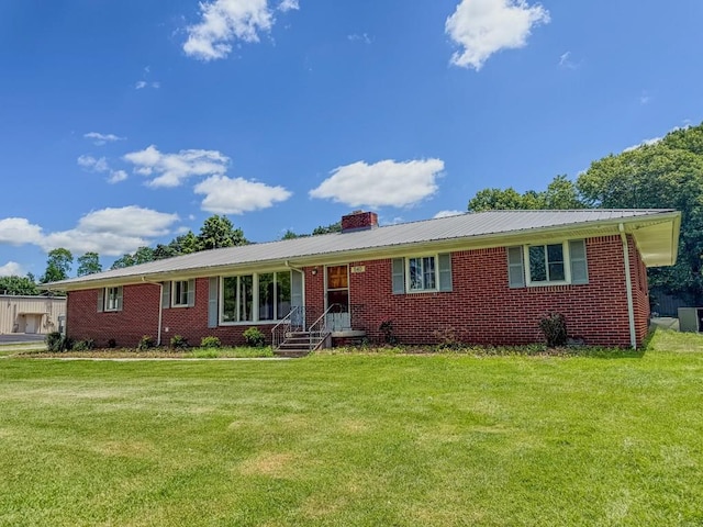 540 4th Ave, Baxter, TN 38544 - single story home with a front yard, a chimney, brick siding, and a metal roof