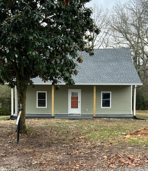 view of front of house with covered porch and roof with shingles