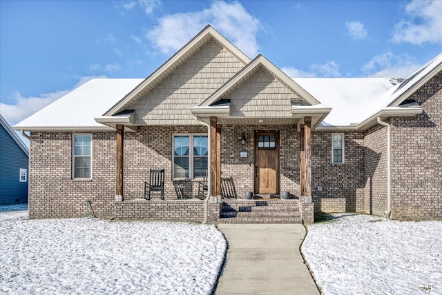 view of front of property featuring a porch and brick siding