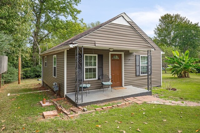 view of front facade with a patio and a front lawn