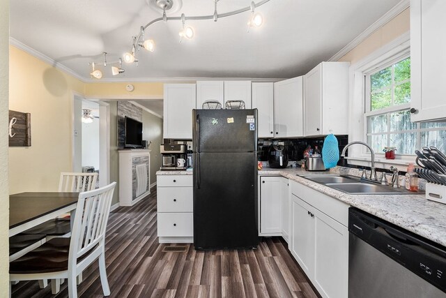 kitchen featuring dishwasher, a sink, freestanding refrigerator, and white cabinets