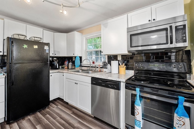 kitchen featuring a sink, white cabinets, appliances with stainless steel finishes, backsplash, and dark wood finished floors