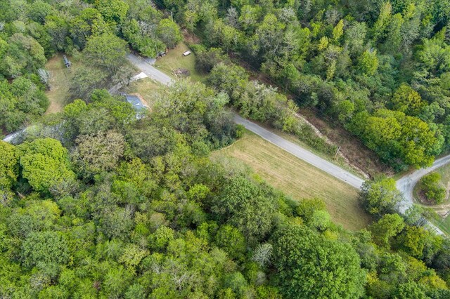 birds eye view of property with a forest view