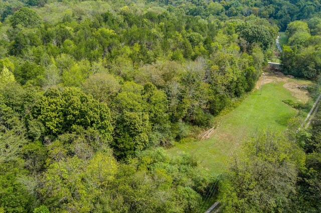 birds eye view of property featuring a wooded view