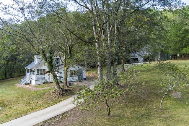 view of front of property with a porch and a front yard