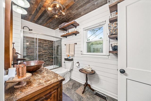 full bathroom featuring visible vents, toilet, wooden ceiling, wood walls, and a sink