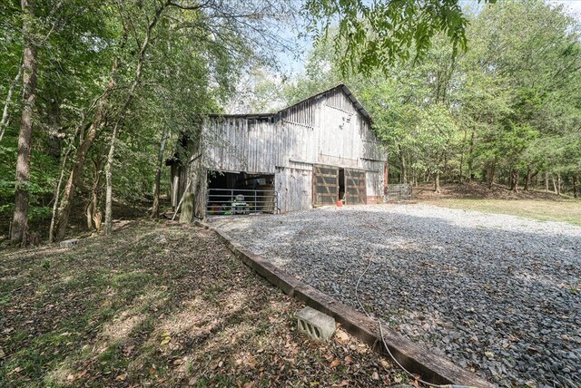 view of side of property with an outbuilding, a barn, and a garage