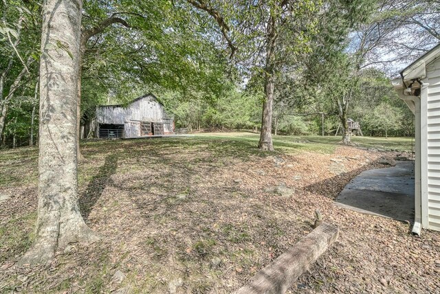 view of yard featuring an outdoor structure and a barn