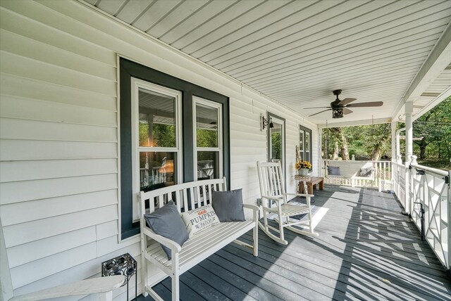 deck featuring covered porch and a ceiling fan