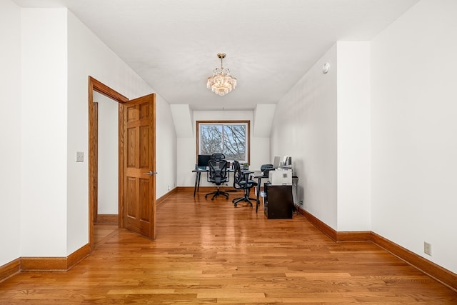 office featuring a chandelier, light wood-type flooring, and baseboards