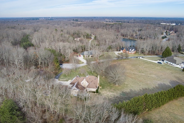 drone / aerial view featuring a wooded view