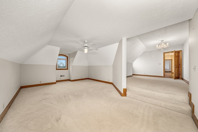 additional living space with light carpet, baseboards, vaulted ceiling, a textured ceiling, and ceiling fan with notable chandelier