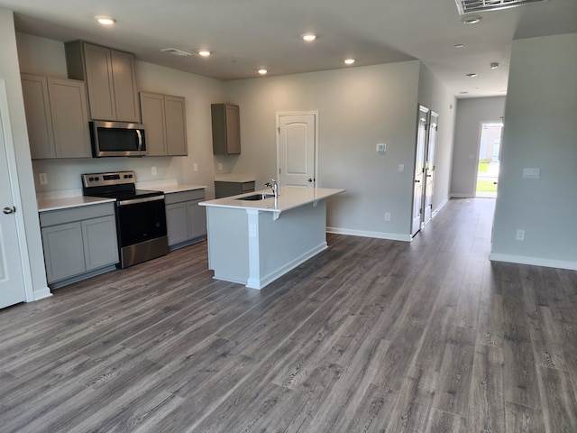 218 Dale Mires Ln, Baxter, TN 38544 - kitchen with appliances with stainless steel finishes, gray cabinetry, a kitchen island with sink, dark wood-style flooring, and a sink
