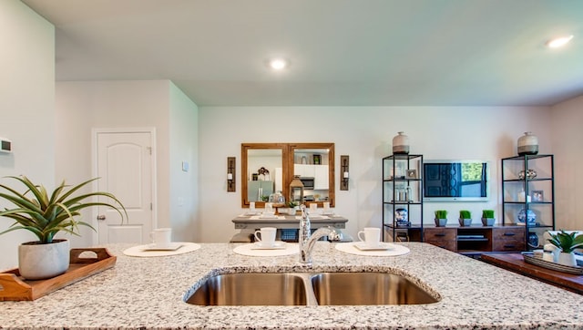 218 Dale Mires Ln, Baxter, TN 38544 - kitchen featuring a sink, open floor plan, light stone countertops, and recessed lighting