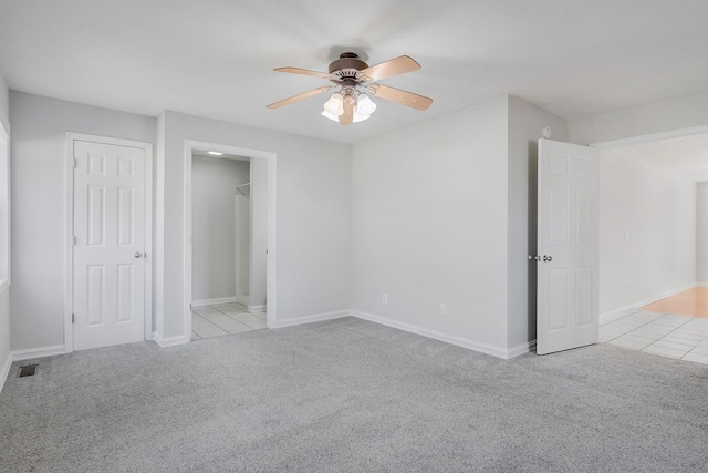 unfurnished bedroom with light carpet, baseboards, visible vents, and a ceiling fan