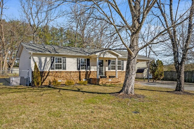 ranch-style home featuring crawl space, a front yard, fence, and brick siding